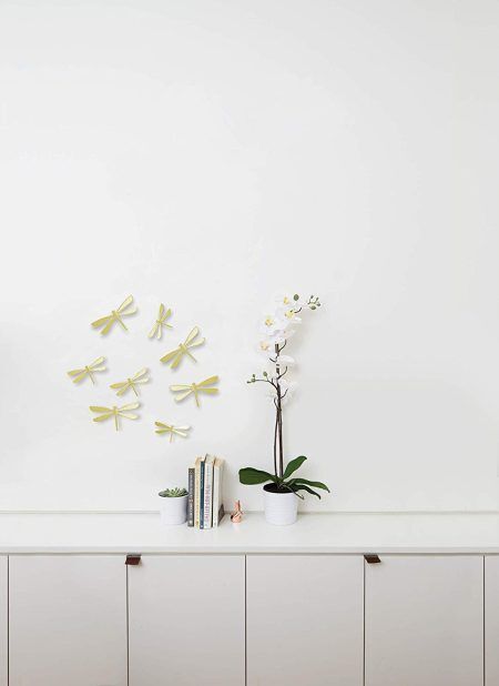 <p><span style="font-size: small;"><strong>UMBRA Комплект декорация за стена “WALLFLUTТER“ </strong></span><br /><span style="font-size: small;"><strong>• </strong></span><strong>Цвят:</strong> месинг<br />• <strong>Ефект 3D<br />• Сет от 8 бр водни кончета</strong><br />•<strong> Закрепване за стена (с включени двойнолепящи лепенки)</strong><br />• <strong>Четири</strong> р<strong>азмера в комплект:</strong> от (11,4 x 6,4 ) до (14,6 х 8,3) cm<br />• <strong>Материал:</strong> пластмаса<br /><strong>Производител: UMBRA / Канада<br /></strong><em><strong>DESIGN: ALAN WISNIEWSKI & MARION LANKTREE</strong></em></p><br />Марка: Umbra HK Limited <br />Модел: UMBRA 1013366-104<br />Доставка: 2-4 работни дни<br />Гаранция: 2 години